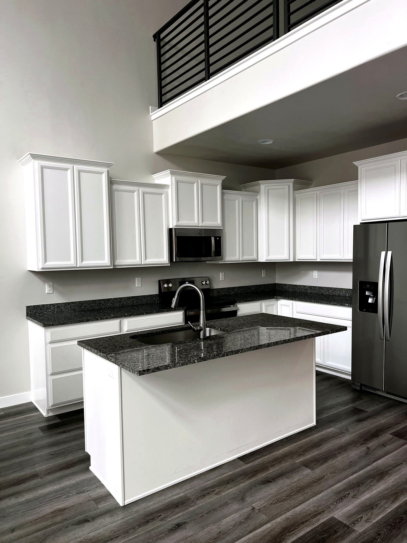Bright white kitchen counters polished after a Sun Ray Cleaning visit